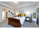 Comfortable main bedroom with a wooden bed frame and bright yellow pillows on the bed at 3100 Cheyney Park Dr, Charlotte, NC 28269