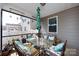 Cozy screened-in porch featuring comfortable seating, a glass table, and lush plants for outdoor relaxation at 3100 Cheyney Park Dr, Charlotte, NC 28269