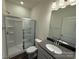 Modern bathroom featuring a glass-enclosed shower, gray vanity, and sleek fixtures at 317 Maidstone Dr # 57, Monroe, NC 28110