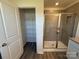 Bathroom showcases a tiled shower with glass door, accompanied by a shelving closet at 317 Maidstone Dr # 57, Monroe, NC 28110