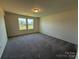 Carpeted bedroom with two windows providing natural light at 317 Maidstone Dr # 57, Monroe, NC 28110