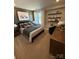 Cozy bedroom with plaid wallpaper, a soft carpet, stylish furnishings, and natural lighting at 317 Maidstone Dr # 57, Monroe, NC 28110