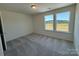 Carpeted bedroom with two windows providing natural light at 317 Maidstone Dr # 57, Monroe, NC 28110