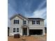 Two-story home featuring light siding, black shutters, an attached garage, and a welcoming front porch at 317 Maidstone Dr # 57, Monroe, NC 28110