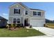 Two-story home featuring a well-manicured lawn, two-car garage, and inviting front entrance at 317 Maidstone Dr # 57, Monroe, NC 28110