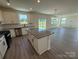 Spacious kitchen with island, stainless steel appliances, and tile backsplash at 317 Maidstone Dr # 57, Monroe, NC 28110