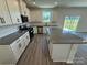 Spacious kitchen showcasing an island, modern appliances, gray counters and ample cabinet space at 317 Maidstone Dr # 57, Monroe, NC 28110