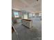 Spacious, unfinished kitchen with white cabinets, an island, and an adjacent living area at 317 Maidstone Dr # 57, Monroe, NC 28110