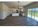 Open floor plan with kitchen, dining area and sliding glass door leading to backyard at 317 Maidstone Dr # 57, Monroe, NC 28110