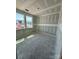 An unfinished room offers potential with ample natural light streaming through two windows at 317 Maidstone Dr # 57, Monroe, NC 28110