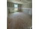 Unfinished room offers a blank canvas with natural light streaming through a window at 317 Maidstone Dr # 57, Monroe, NC 28110