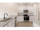 Modern kitchen featuring stainless steel appliances, granite counters, and white cabinetry at 3246 Maple Ridge Dr, Gastonia, NC 28052