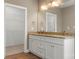 Elegant bathroom featuring double sinks with granite countertops, and a glimpse into a walk-in closet at 325 East St, Heath Springs, SC 29058