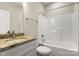 Bathroom featuring white cabinets and shower with a granite counter top at 325 East St, Heath Springs, SC 29058