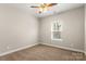 Cozy bedroom features neutral carpet, a ceiling fan, and natural light from the window at 325 East St, Heath Springs, SC 29058