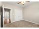 Bedroom with neutral carpet boasts double door closet and neutral walls at 325 East St, Heath Springs, SC 29058