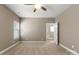 Neutral bedroom featuring a ceiling fan, plush carpeting, and natural light streaming through the window at 325 East St, Heath Springs, SC 29058