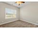 Cozy bedroom featuring plush carpeting, a ceiling fan, and a bright window view at 325 East St, Heath Springs, SC 29058