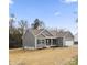 Charming home exterior with grey siding, well-maintained lawn, and attached garage at 325 East St, Heath Springs, SC 29058