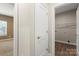 Hallway view leading to the laundry room and bedroom, featuring hardwood flooring and neutral wall colors at 325 East St, Heath Springs, SC 29058