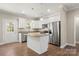 Updated kitchen featuring granite countertops, stainless appliances, a center island, and ample natural light at 325 East St, Heath Springs, SC 29058