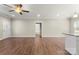 Open-concept living area with hardwood flooring, neutral walls, ceiling fan, and views of the kitchen at 325 East St, Heath Springs, SC 29058