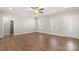 Open living space with wood-look floors, ceiling fan, and natural light at 325 East St, Heath Springs, SC 29058