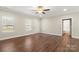 Spacious living room with neutral paint, lots of windows, and hardwood floors at 325 East St, Heath Springs, SC 29058