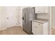 A Stainless steel refrigerator sits next to white cabinets and a door in this new kitchen at 3324 Burberry Dr, Gastonia, NC 28052