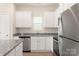 Contemporary kitchen with white cabinets, stainless steel appliances, and granite countertops at 3335 Burberry Dr, Gastonia, NC 28052