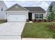 Charming one-story home with a well-manicured lawn, attached two-car garage, and traditional design elements at 3406 Saddlebred Dr, Gastonia, NC 28052