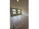 Empty bedroom with natural light pouring through windows and protective covering on the floor at 346 Knotty Wood Dr # 71, Monroe, NC 28110