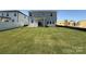 Expansive backyard features a lush lawn and a covered patio, perfect for outdoor entertaining and relaxation at 346 Knotty Wood Dr # 71, Monroe, NC 28110