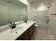 Bathroom features a double sink vanity with modern faucets, a tub, and neutral tile at 346 Knotty Wood Dr # 71, Monroe, NC 28110