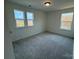 Bedroom featuring neutral carpet, natural light, and a view of the surrounding neighborhood at 346 Knotty Wood Dr # 71, Monroe, NC 28110