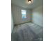 Cozy bedroom featuring neutral paint, carpet, and a window for natural light at 346 Knotty Wood Dr # 71, Monroe, NC 28110