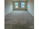 Bright bedroom features plush carpeting and two windows with natural light at 346 Knotty Wood Dr # 71, Monroe, NC 28110