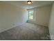 A cozy bedroom with neutral carpet, natural light, and a warm, inviting atmosphere at 346 Knotty Wood Dr # 71, Monroe, NC 28110