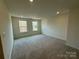 A bright bedroom with neutral carpet, ample light and ready for your personal touches at 346 Knotty Wood Dr # 71, Monroe, NC 28110