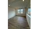 Bright bedroom showcasing two large windows, neutral paint, and carpet at 346 Knotty Wood Dr # 71, Monroe, NC 28110