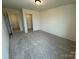 Large bedroom showcasing neutral carpet and offering a glimpse into a walk-in closet at 346 Knotty Wood Dr # 71, Monroe, NC 28110