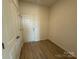 Clean and simple entryway with wood floors and classic paneled white doors at 346 Knotty Wood Dr # 71, Monroe, NC 28110