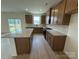Well-equipped kitchen with granite counters, stainless appliances, kitchen island and seamless access to backyard at 346 Knotty Wood Dr # 71, Monroe, NC 28110
