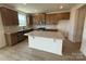 Open kitchen with stainless appliances, wood cabinets, granite counters, and a central island at 346 Knotty Wood Dr # 71, Monroe, NC 28110