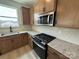 Well-lit kitchen features granite countertops, stainless steel appliances and ample wood cabinets at 346 Knotty Wood Dr # 71, Monroe, NC 28110