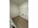 Dedicated laundry room featuring laminate flooring and overhead wire shelf at 346 Knotty Wood Dr # 71, Monroe, NC 28110