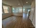 Spacious, light-filled open-concept living room with wood floors and large windows overlooking the neighborhood at 346 Knotty Wood Dr # 71, Monroe, NC 28110