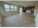 Spacious living room boasts wood-look flooring, natural light and flows into kitchen area at 346 Knotty Wood Dr # 71, Monroe, NC 28110