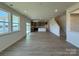 Bright and spacious living room with abundant natural light, sleek flooring, an open floor plan, and a kitchen view at 346 Knotty Wood Dr # 71, Monroe, NC 28110