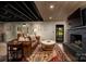 This basement features wood look tile, a leather couch, and a fireplace at 4313 Kingswood Rd, Charlotte, NC 28226